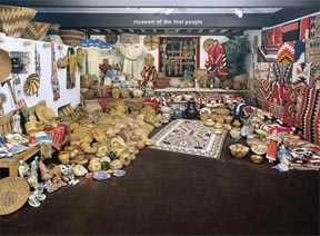 Navajo rugs and Navajo blankets and antique Indian baskets in the Navajo rug room at Len Wood's Indian Territory Gallery in Laguna Beach, California.